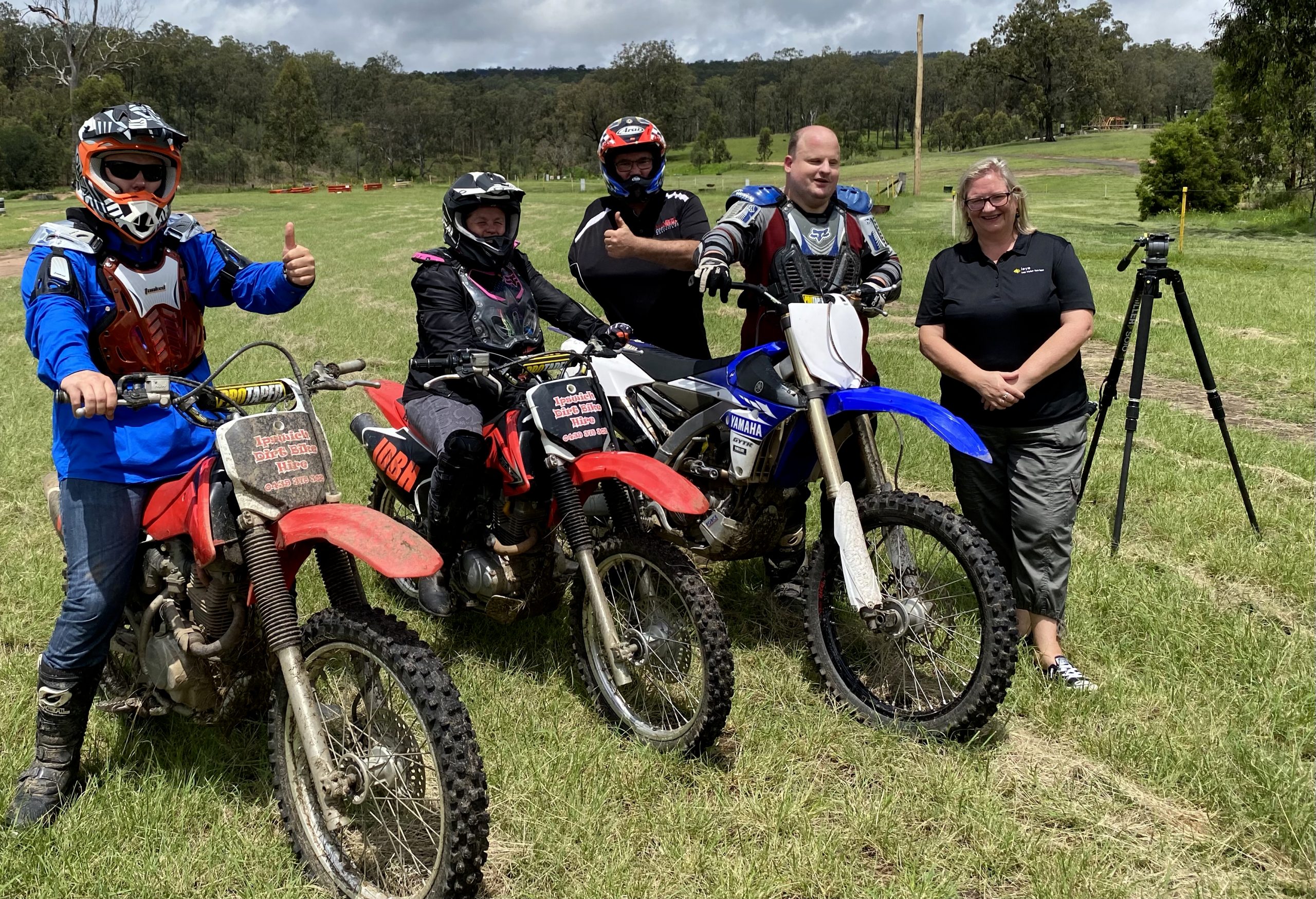 Photo of Lisa standing beside 4 people on motorbikes.