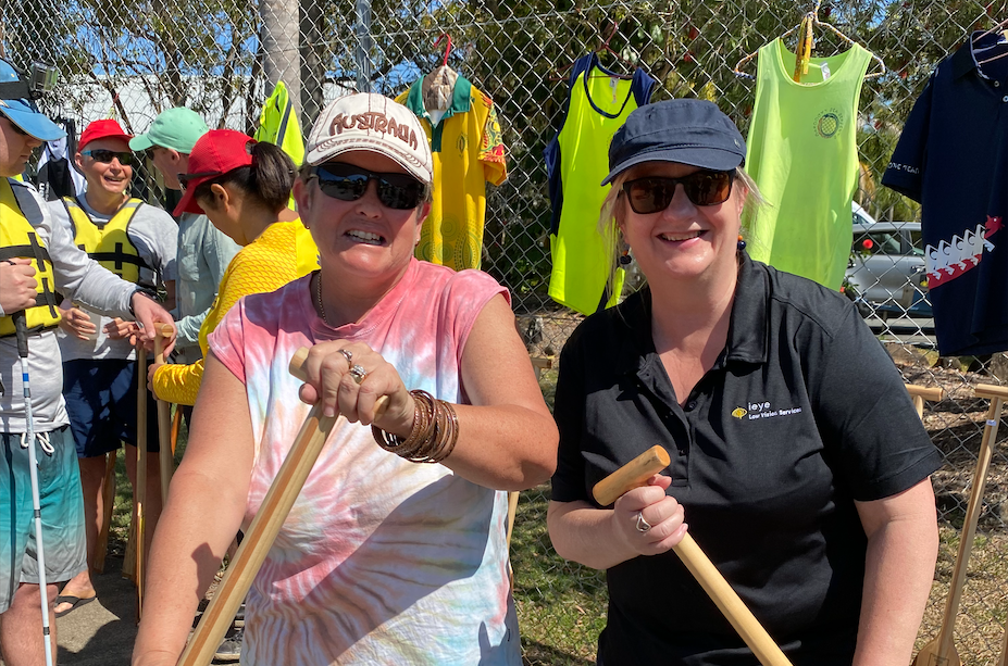 Photo of Lisa and clients with croquet sticks.